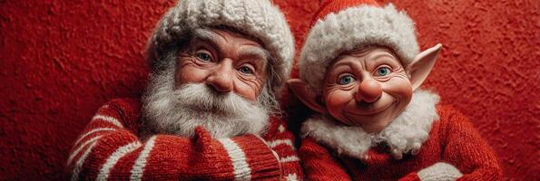 Two cheerful holiday characters with bright smiles posing against a festive red background during the winter season celebration photo