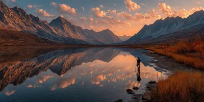 Majestic mountain landscape with serene lake reflection at sunset in a remote wilderness area photo