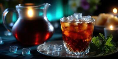 Refreshing iced tea served in a glass with ice cubes and a pitcher in a cozy setting during the evening photo