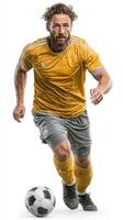 Male soccer player in yellow jersey running towards soccer ball on white background during a training session photo
