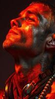 Unique portrait of a man with artistic body paint and intense expression captured in dramatic lighting photo