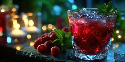 Refreshing raspberry drink with ice and mint garnished in a glass at a cozy evening setting photo