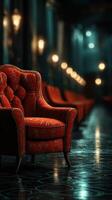 Elegant red chair in a dimly lit hall with vintage lighting and polished floors photo