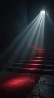 Light beams illuminate dark stairway with red carpet in mysterious underground setting photo