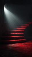 Stairs illuminated by light with red carpeting in an artistic interior space photo