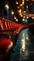 Elegant red chairs line a dimly lit theater awaiting the next performance with ambient lighting creating a rich atmosphere photo