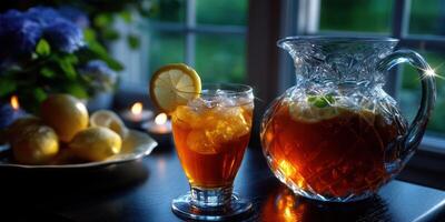Refreshing iced tea served in a glass with lemon garnish alongside a pitcher and fresh lemons in a cozy evening setting photo