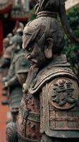 Historic warrior statues line the path in a tranquil garden in the late afternoon light photo