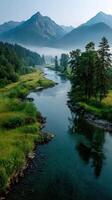 Majestic river winding through lush valley and mountains at dawn under soft light photo