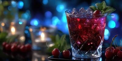 Refreshing cocktail garnished with cherries and mint on a table with ambient lighting in the evening photo