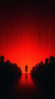 Audience captivated by a speaker under dramatic red lighting in a dimly lit theater setting during an engaging presentation photo
