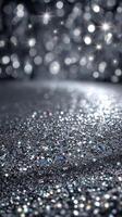 Sparkling silver glitter on a dark background with shimmering bokeh lights creating a festive atmosphere photo