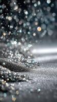 Snowflakes gently fall on sparkling silver ground, creating a magical winter atmosphere during a serene night photo