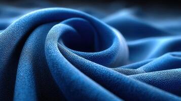 Soft blue fabric creates elegant folds with intricate textures in a close-up view under soft lighting photo