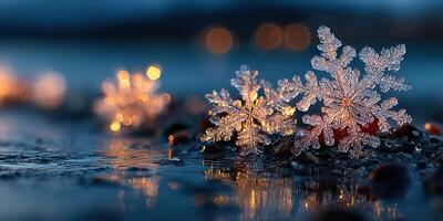 Delicate snowflakes resting on dark stones by a tranquil lake at twilight, illuminated by soft glowing lights in the background photo