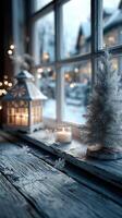 Winter evening view with a candle, lantern, and a miniature tree by a cozy window photo