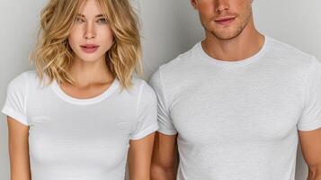 Couple poses in casual white shirts against neutral background in modern indoor setting photo