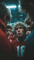 Intense team huddle before a crucial soccer match during a rainy game day at the stadium photo