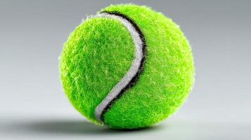 Bright green tennis ball with textured surface resting on a simple background photo