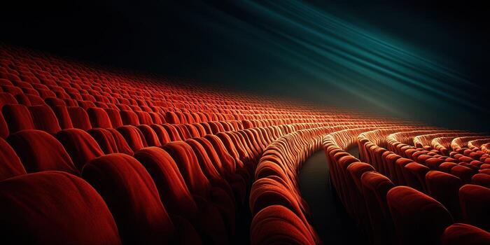 Empty theater with red seating shining under blue lighting showcases a dramatic atmosphere for potential performances photo