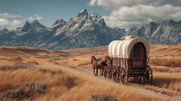 Historic wagon travels along a winding trail in the mountains during a sunny day photo