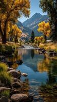 Scenic view of a serene river surrounded by vibrant autumn trees in a mountainous landscape during a sunny day photo