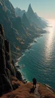 Hiker exploring rugged coastal cliffs at sunrise in a serene mountain landscape photo
