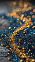 Shimmering blue and gold glitter scattered across a textured surface in artistic arrangement photo