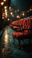 Rustic velvet chair in an empty theater with warm lights glowing softly in the background at night photo