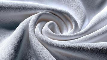 Soft white fabric swirling gracefully to create a visually appealing texture in natural light photo