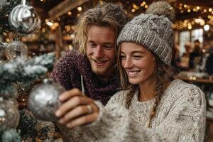 Couple decorates Christmas tree with ornaments in a cozy cabin during winter evening photo