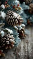 Beautiful winter arrangement with pine cones and snowy branches on rustic wooden surface photo