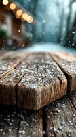 Snowflakes gently falling on a rustic wooden table in a serene winter landscape photo