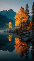Autumn landscape with vibrant trees reflecting on calm water in mountainous region during early morning light photo