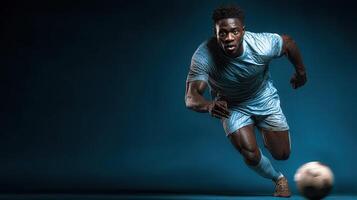 Athlete in blue soccer uniform sprinting with focus on a dark background during an intense match photo