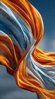 Colorful fabric waves dance under a clear sky during a sunny day in nature photo