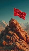 Red flag waves atop rocky mountain peak surrounded by majestic snow-capped mountains at sunset photo