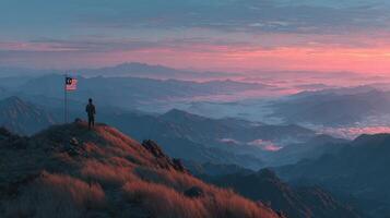 Sunset view from mountaintop with flag and lone figure overlooking valley in Malaysia photo