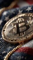 Gold Bitcoin coin resting on a textured American flag background during a financial discussion about cryptocurrency trends photo