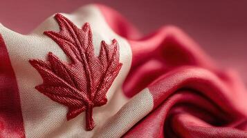 Canadian flag with detailed embroidery displayed on a textured background photo