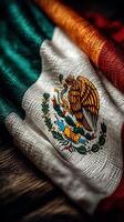 Mexican flag displayed on a rustic wooden surface showcasing vibrant colors and intricate emblem symbolizing national pride photo