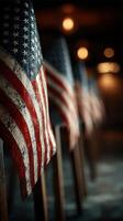 Several weathered American flags display a sense of patriotism and history in a dimly lit setting photo