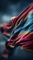 Colorful fabric waving in the wind with striking blue and red stripes creating an elegant texture photo