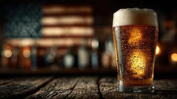 Cold beer served in a glass with bubbles in a rustic setting with blurred bottles and an American flag background photo