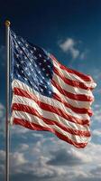 American flag waving proudly against a clear blue sky during the day photo