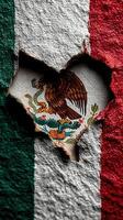 Detail of a heart-shaped hole revealing the Mexican flag with its vibrant colors and emblem photo