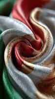 Colorful fabric with green, white, red, and gold textures showcasing intricate patterns and folds in natural light photo