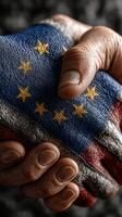 Two hands clasped together, holding a fabric representing unity with the European flag, symbolizing collaboration and solidarity photo