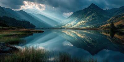 Mountain landscape reflecting in lake during golden hour with dramatic clouds and sunlight photo