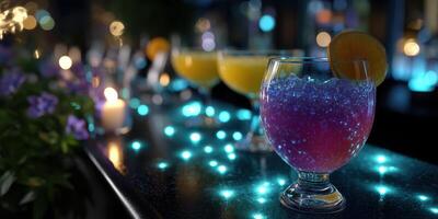 Vibrant cocktails with glowing decorations at a nighttime outdoor gathering by the bar photo